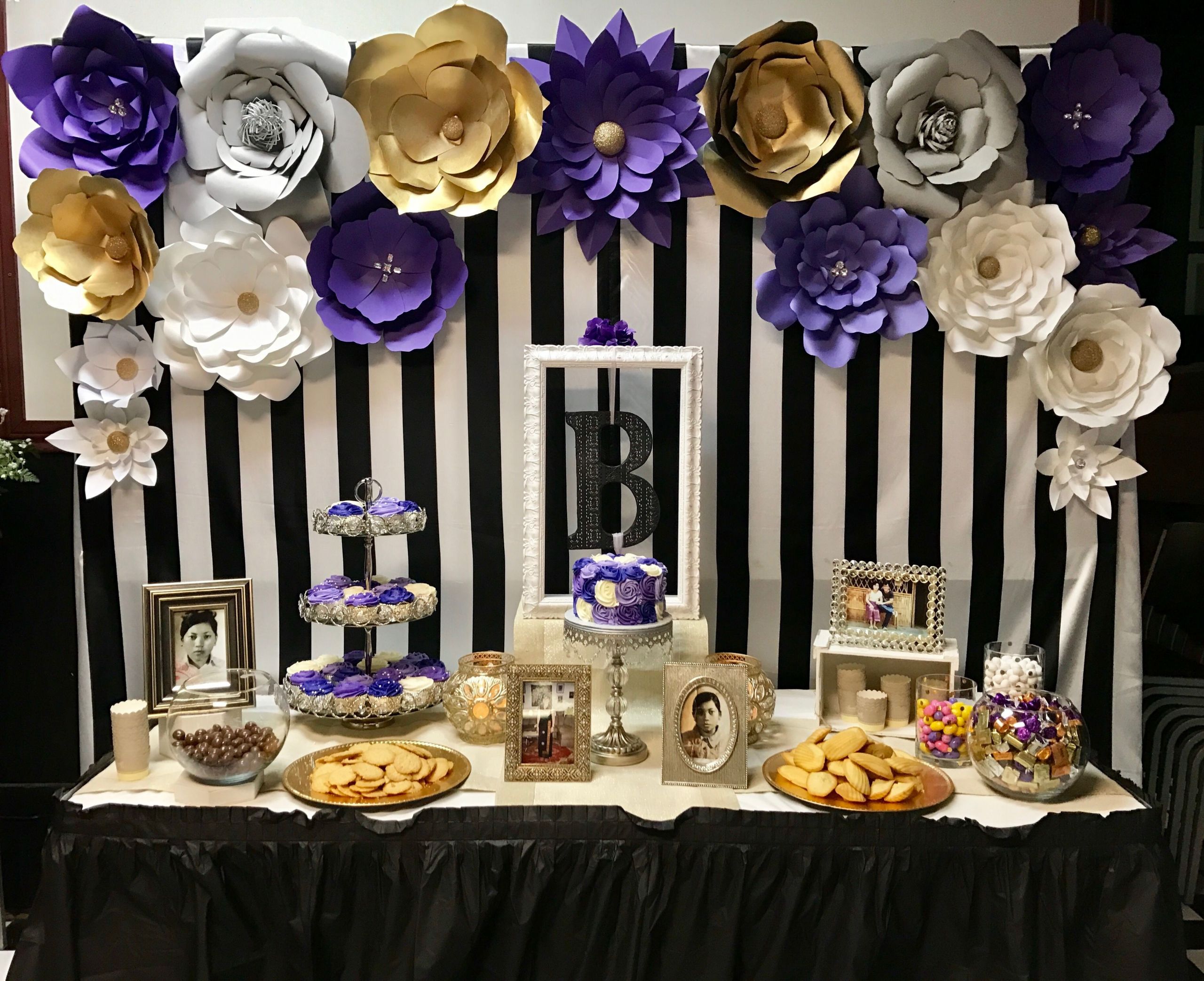 60th Birthday Table Decorations
 Dessert table with paper flowers backdrop for purple