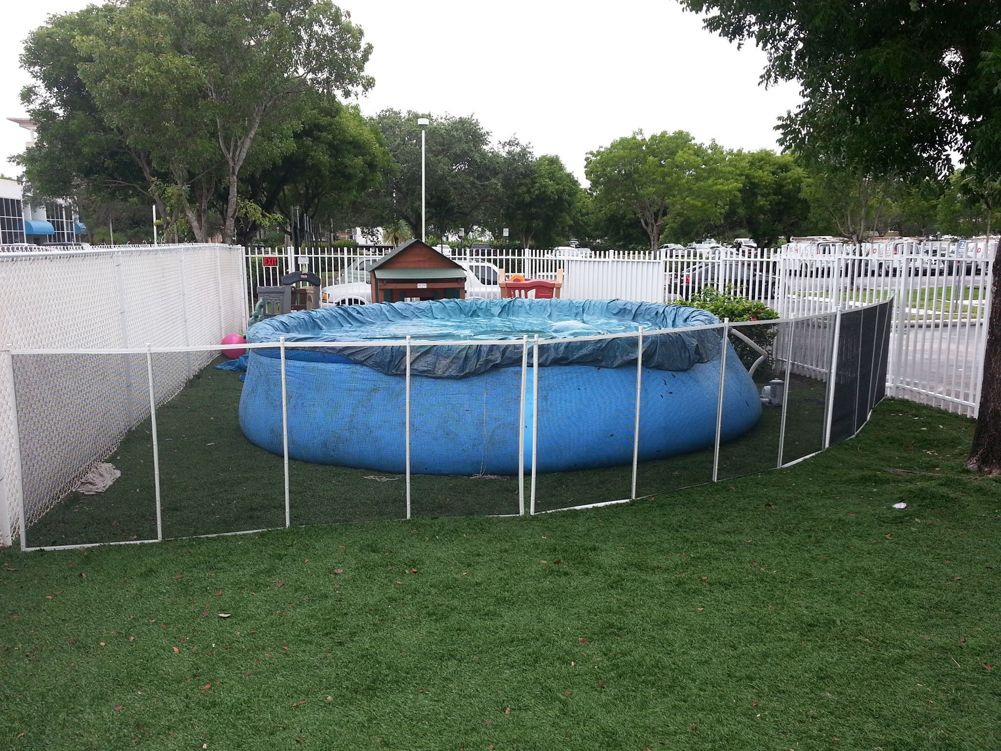 Above Ground Pool Fence Regulations
 black mesh pool fence with white poles installed in grass