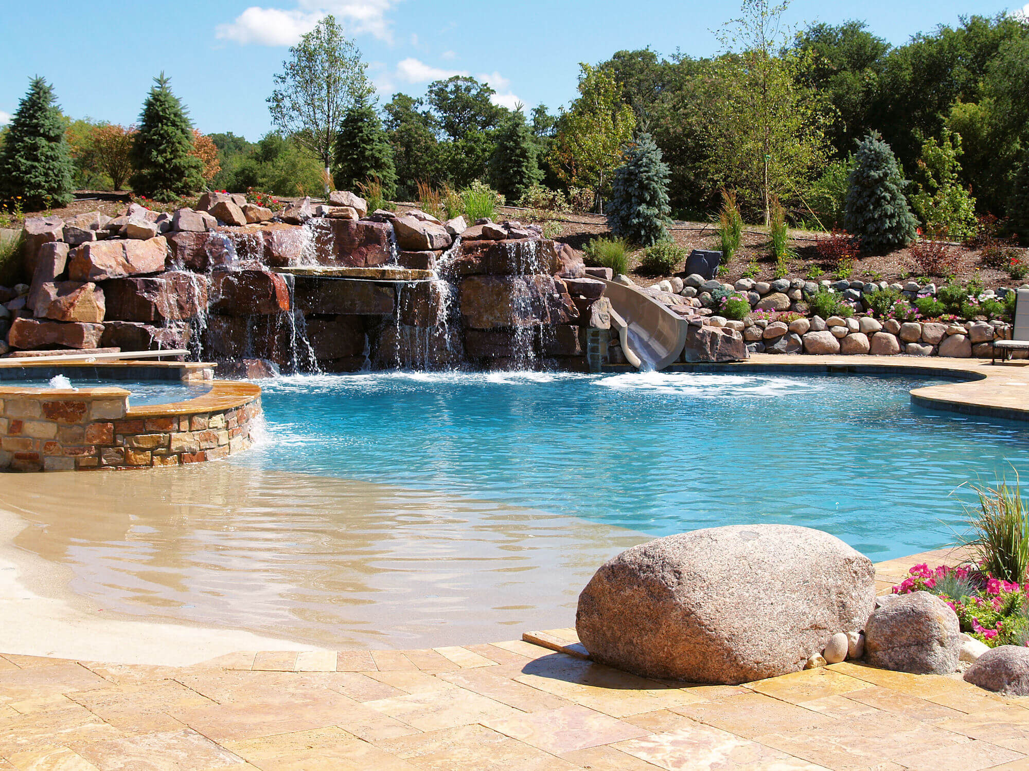 Backyard Beach Pool
 A beach entry and custom rock slide create a one of a kind