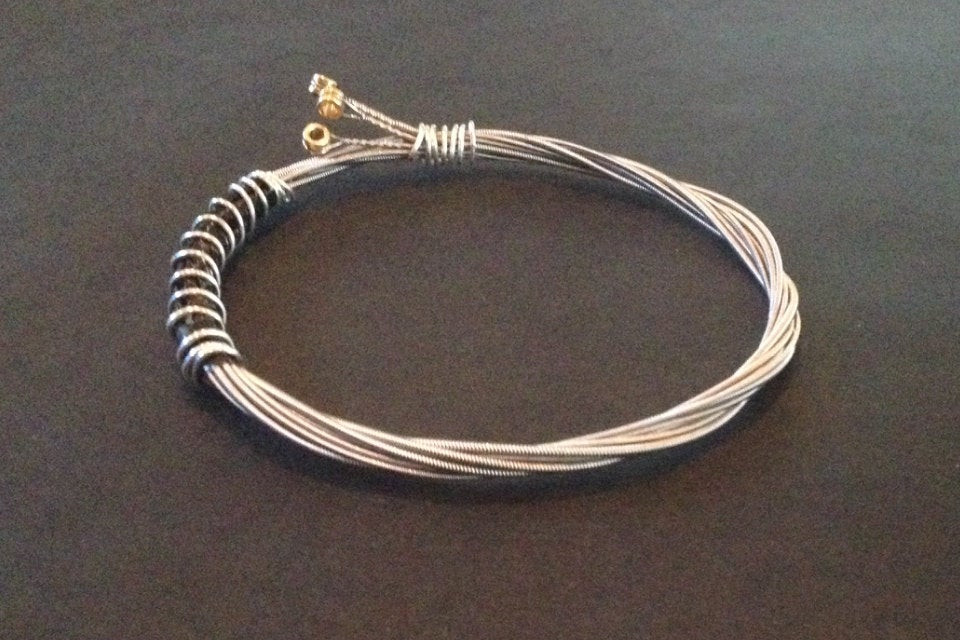 Guitar String Bracelet
 A handmade recycled guitar string bracelet bangle bound with