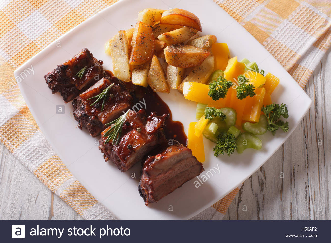 Side Dishes For Barbecue Ribs
 BBQ pork ribs with a side dish of ve ables close up on a