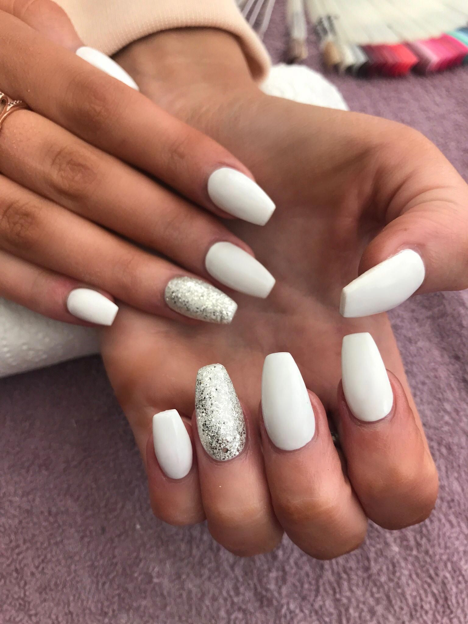 White And Silver Glitter Nails
 White coffin shaped acrylic nails with silver glitter